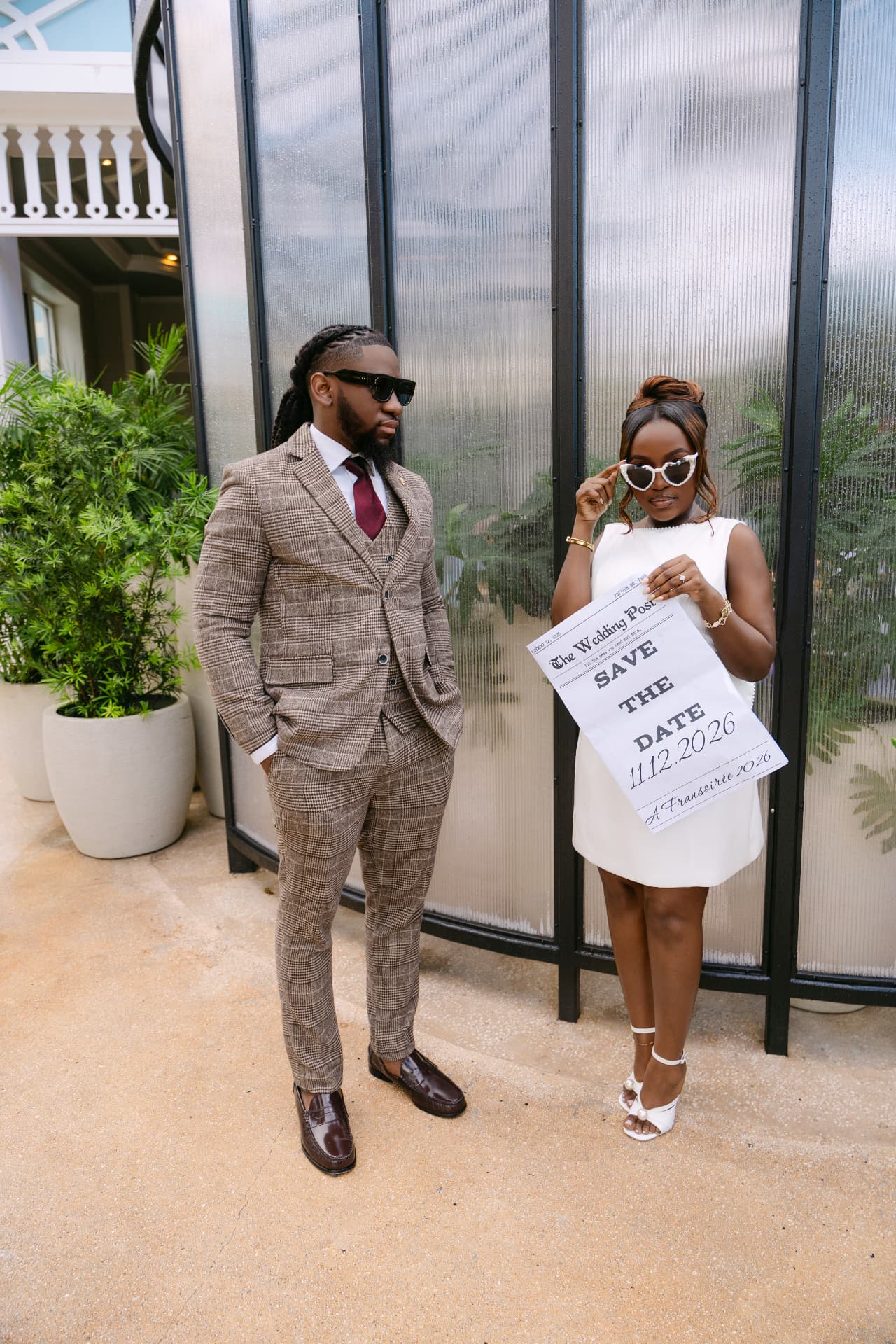 Couple holding a save-the-date newspaper announcement