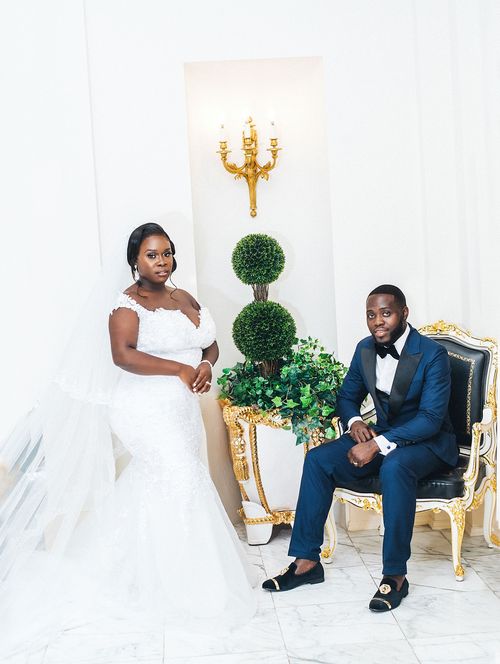 Elegant indoor portrait of the couple in a gilded salon