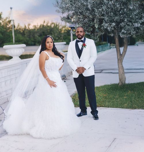 Bride and groom at dusk in a garden courtyard