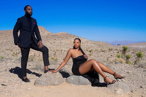 Editorial desert portrait of the couple among rocks