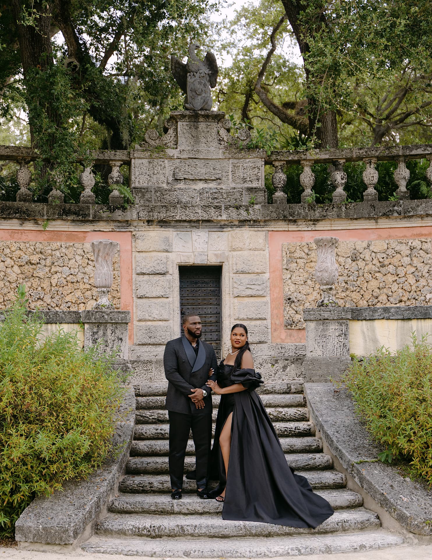 Couple on grand coral-stone stairs at a historic villa