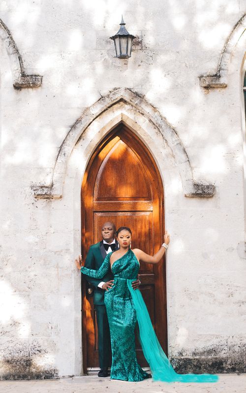 Couple in emerald sequins before a gothic chapel door