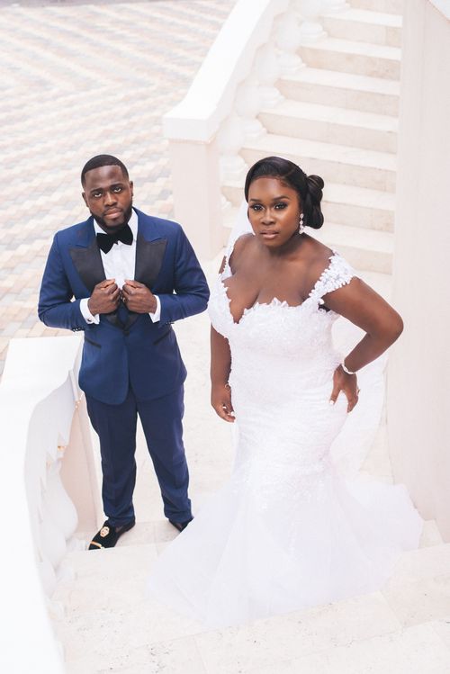 Couple on a limestone staircase in navy and lace
