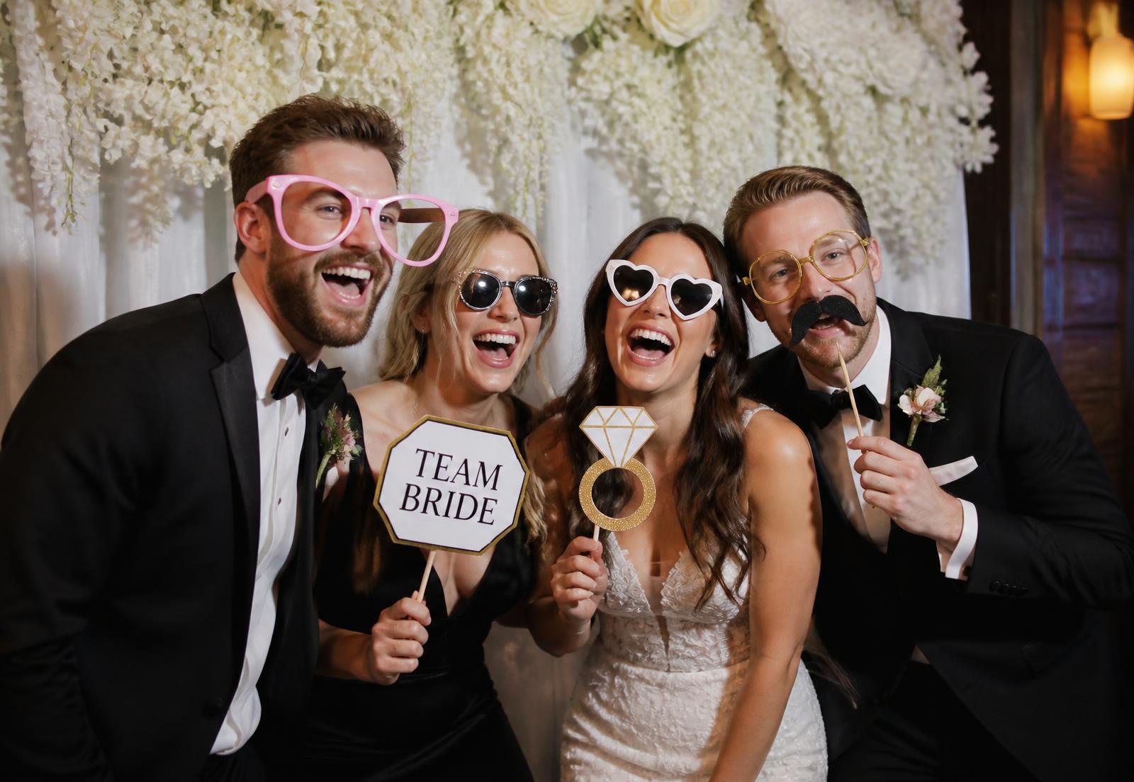 Wedding guests laughing in the photo booth